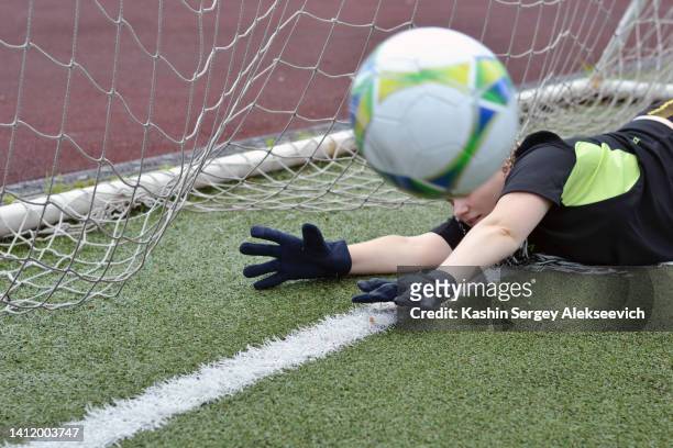 female goalkeeper catching a soccer ball. - woman goalie stock pictures, royalty-free photos & images
