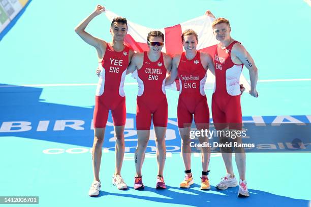 Alex Yee, Sophie Coldwell, Georgia Taylor-Brown and Samuel Dickinson of Team England pose on the finish line after winning gold during Triathlon...