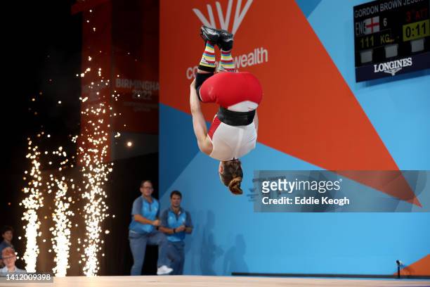Jessica Gordon Brown of Team England celebrates with a somersault after performing a clean & jerk during Women's 59kg Final on day three of the...