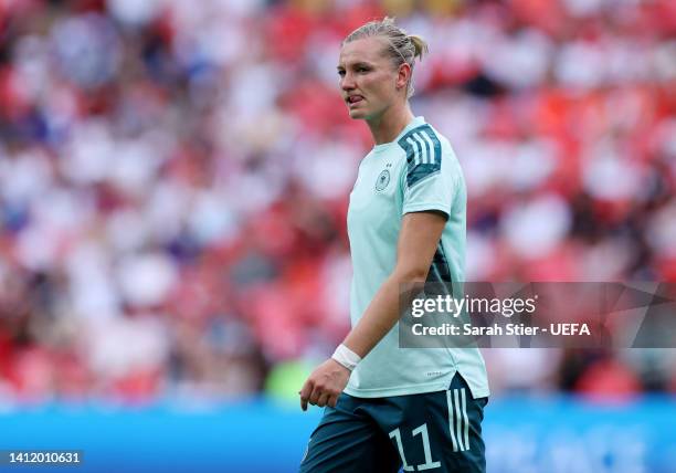 Alexandra Popp of Germany looks on before getting injured as she drops to the batch prior the UEFA Women's Euro 2022 final match between England and...