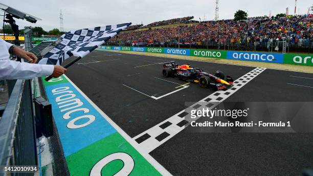Race winner Max Verstappen of the Netherlands driving the Oracle Red Bull Racing RB18 takes the chequered flag during the F1 Grand Prix of Hungary at...