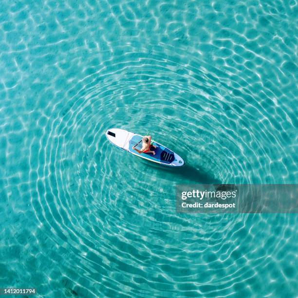 mature man on a paddleboard on the sea - montenegrin stock pictures, royalty-free photos & images