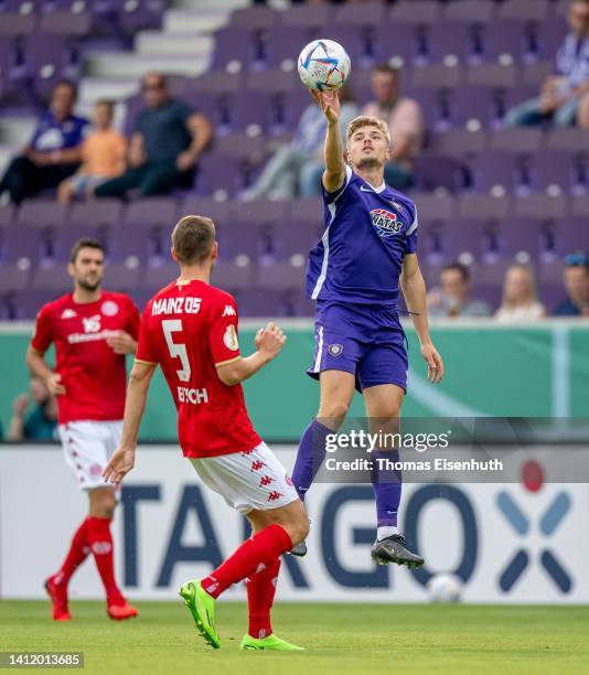 Elias Huth of Aue in action with Maxim Leitsch of Mainz during the DFB Cup first round match between Erzgebirge Aue and 1. FSV Mainz 05 at...