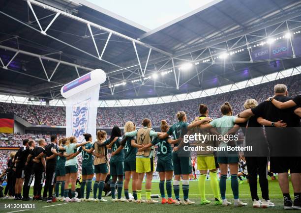 Germany players stand for the national anthem prior to kick off during the UEFA Women's Euro 2022 final match between England and Germany at Wembley...