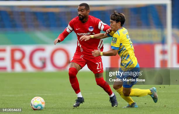 Keita Endo of Eintracht Braunschweig challenges Kevin Prince Boateng of Hertha BSC during the DFB Cup first round match between Eintracht...