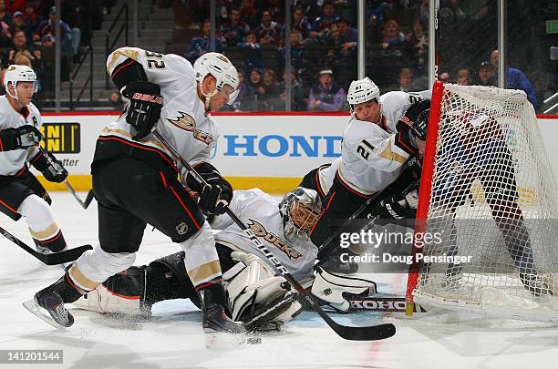 Goalie Jonas Hiller of the Anaheim Ducks defends the goal while Toni Lydman of the Anaheim Ducks clears the puck and Sheldon Brookbank of the Anaheim...