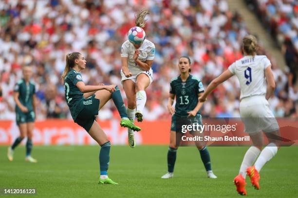 Georgia Stanway of England competes for a header with Jule Brand of Germany during the UEFA Women's Euro 2022 final match between England and Germany...