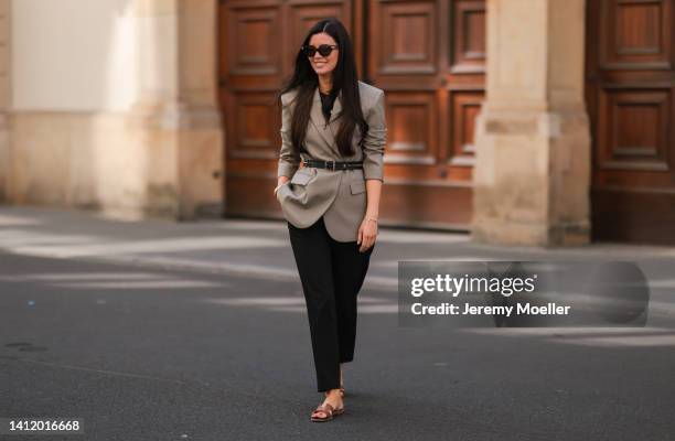 Leo Eberlin is seen wearing Hermes brown leather Oran sandals, a Chanel vintage black zipped belt, Bottega Veneta brown shades, Sandro olive blazer...