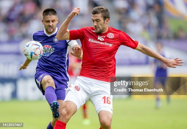 Dimitrij Nazarov of Aue in action with Stefan Bell of Mainz during the DFB Cup first round match between Erzgebirge Aue and 1. FSV Mainz 05 at...