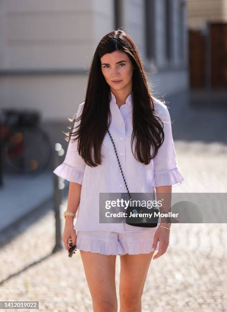 Leo Eberlin is seen wearing Sleeper lilac pastel mini shorts and Sleeper blouse, Chanel mini black bag and & other stories black shades and a golden...