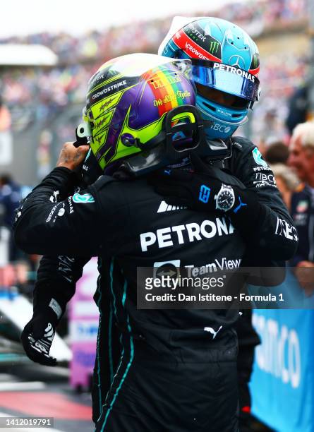 2pm Lewis Hamilton of Great Britain and Mercedes and Third placed George Russell of Great Britain and Mercedes celebrate in parc ferme during the F1...
