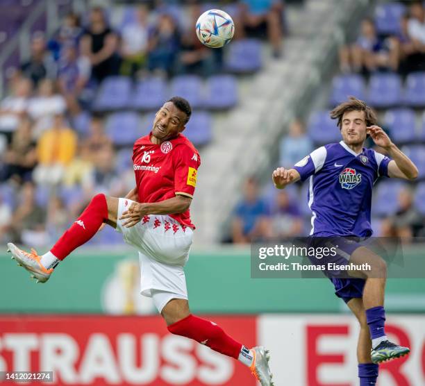 Karim Onisiwo of Mainz jumps for a header with Tim Danhof of Aue during the DFB Cup first round match between Erzgebirge Aue and 1. FSV Mainz 05 at...