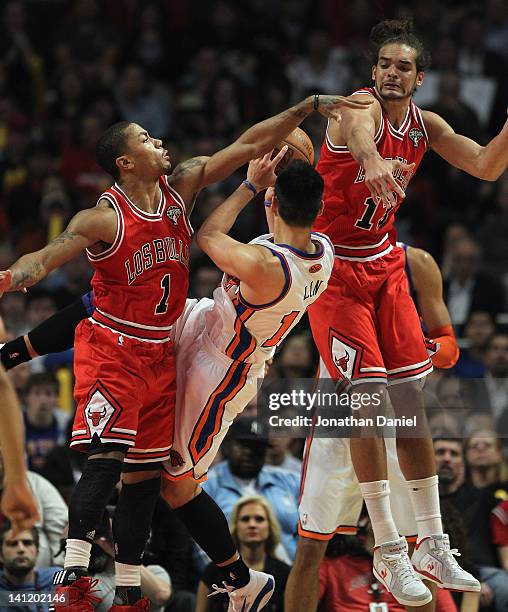 Derrick Rose and Joakim Noah of the Chicago Bulls stop a shot by Jeremy Lin of the New York Knicks at the United Center on March 12, 2012 in Chicago,...