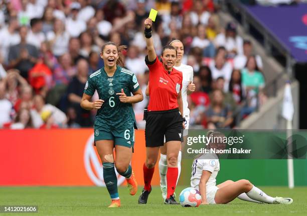 Match Referee, Kateryna Monzul shows the yellow card to Lena Oberdorf of Germany during the UEFA Women's Euro 2022 final match between England and...