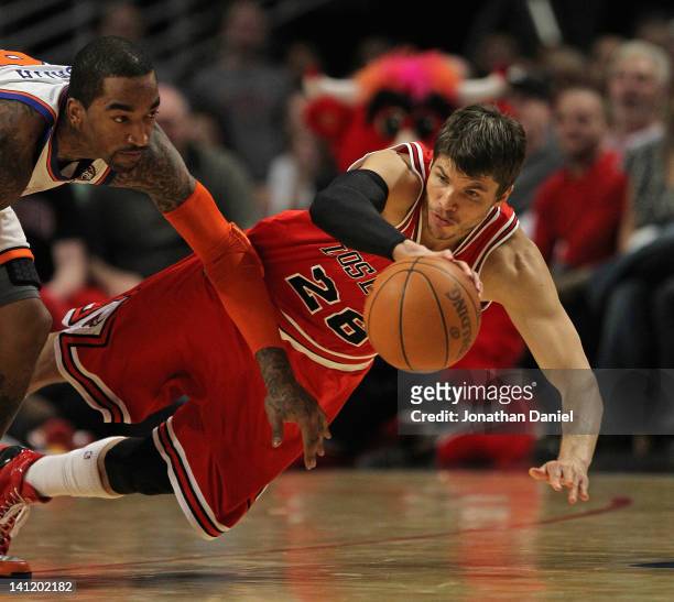 Kyle Korver of the Chicago Bulls saves a loose ball under pressure from Iman Shumpert of the New York Knicks at the United Center on March 12, 2012...