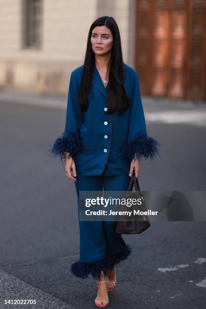 Leo Eberlin is seen wearing Sleeper navy blue feather two piece, Francesco Russo heels, Hermes brown leather 30 Birkin bag on July 28, 2022 in...