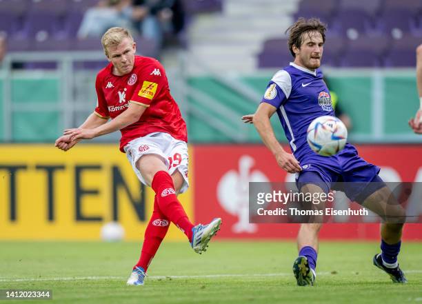 Tim Danhof of Aue in action with Jonathan Burkardt of Mainz during the DFB Cup first round match between Erzgebirge Aue and 1. FSV Mainz 05 at...
