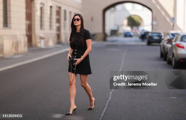 Leo Eberlin is seen wearing a Chanel black leather Heart bag, Alaia Paris black heart heels, Alice McCall black mini skirt with heart buttons,...