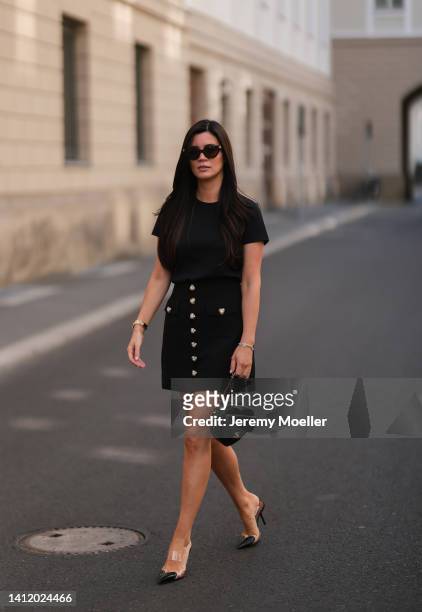 Leo Eberlin is seen wearing a Chanel black leather Heart bag, Alaia Paris black heart heels, Alice McCall black mini skirt with heart buttons,...