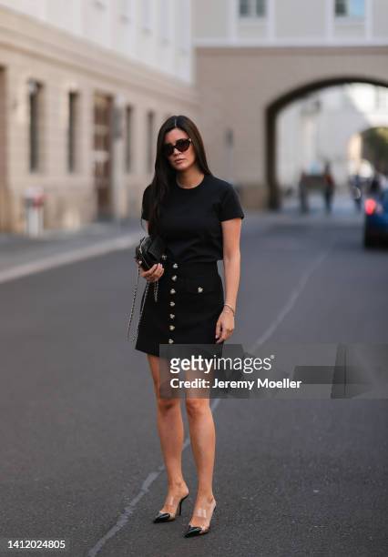 Leo Eberlin is seen wearing a Chanel black leather Heart bag, Alaia Paris black heart heels, Alice McCall black mini skirt with heart buttons,...