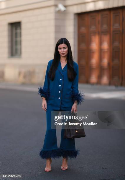 Leo Eberlin is seen wearing Sleeper navy blue feather two piece, Francesco Russo heels, Hermes brown leather 30 Birkin bag on July 28, 2022 in...