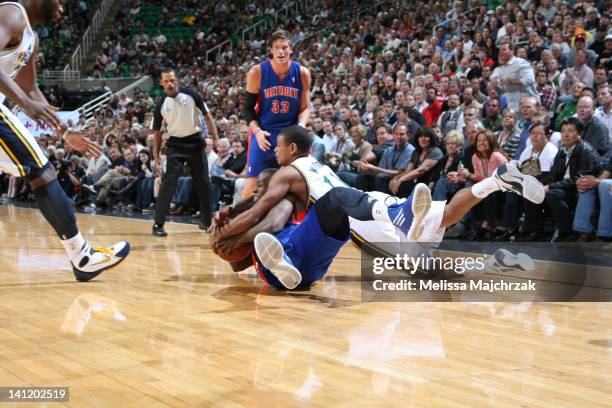 Earl Watson of the Utah Jazz and Rodney Stuckey of the Detroit Pistons battle for the loose ball at Energy Solutions Arena on March 12, 2012 in Salt...