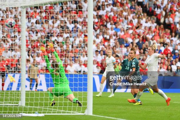 Lina Magull of Germany scores their side's first goal whilst under pressure from Millie Bright as Mary Earps of England attempts to make a save...
