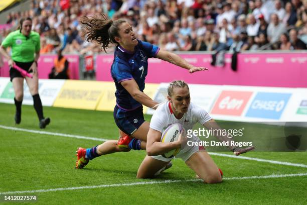 Ellie Boatman of Team England scores a try whilst under pressure from Rhona Lloyd of Team Scotland during the Rugby Sevens Women Playoff for 5th on...