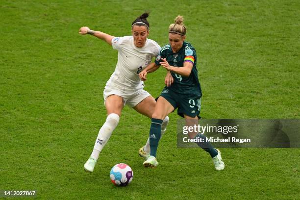 Lucy Bronze of England is challenged by Svenja Huth of Germany during the UEFA Women's Euro 2022 final match between England and Germany at Wembley...