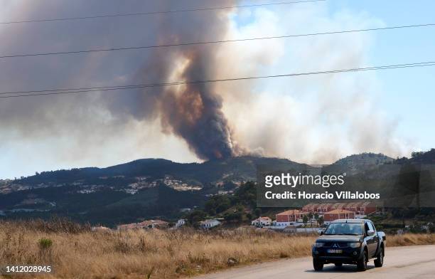 Large plume of smoke is seen at a forest fire being fought by 321 firefighters, 84 vehicles and 9 specialized aircraft on July 31, 2022 in Mafra,...