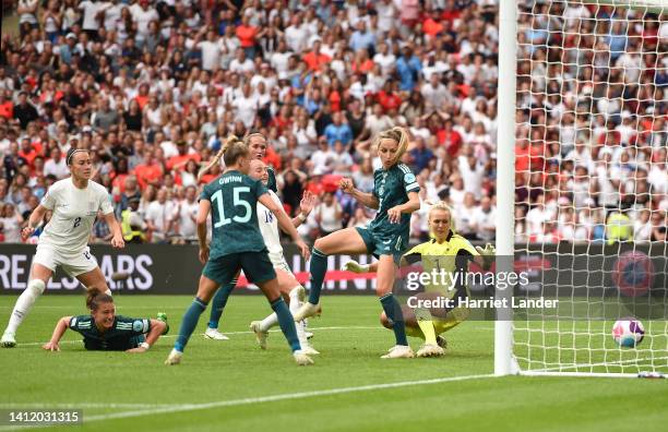 Chloe Kelly of England scores their side's second goal as Kathrin-Julia Hendrich and Merle Frohms of Germany react during the UEFA Women's Euro 2022...