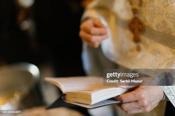 close up of priest's hands - stock photo - prayer book stock pictures, royalty-free photos & images