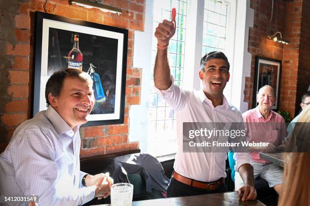 Conservative leadership hopeful Rishi Sunak and MP John Glen celebrate as they watch the Women's Euro 2022 Final with fans at the Bishops Mill pub on...