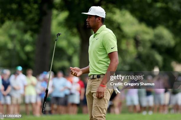 Tony Finau of the United States reacts after missing a putt on the first green during the final round of the Rocket Mortgage Classic at Detroit Golf...