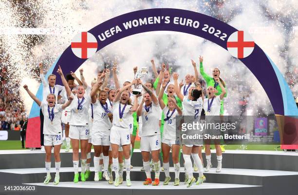 Leah Williamson and Millie Bright of England lift the UEFA Women's EURO 2022 Trophy after their side's victory during the UEFA Women's Euro 2022...