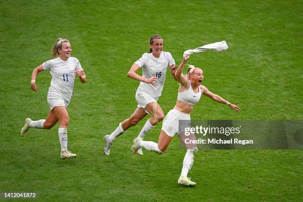 Chloe Kelly of England celebrates scoring the winning goal with team mates Lauren Hemp and Jill Scott during the UEFA Women's Euro 2022 final match...