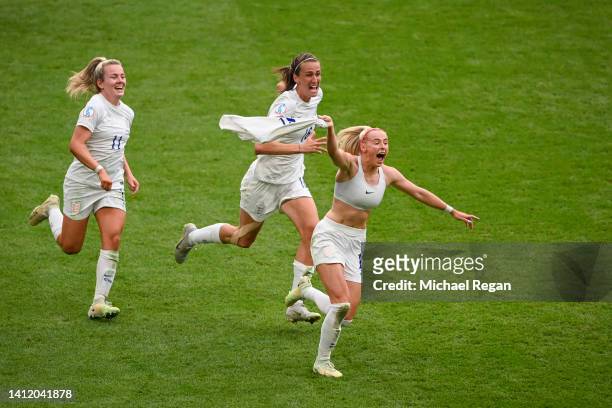 Chloe Kelly of England celebrates scoring the winning goal with team mates Lauren Hemp and Jill Scott during the UEFA Women's Euro 2022 final match...