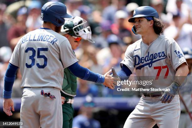 James Outman of the Los Angeles Dodgers is congratulated by Cody Bellinger after hitting a two RBI home run in his Major League Baseball debut...