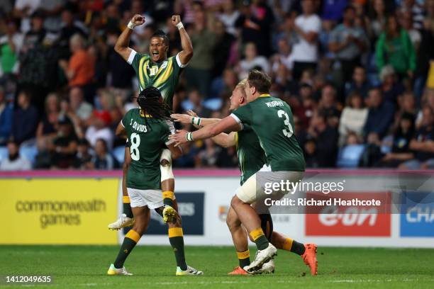 Dewald Human and James Murphy of Team South Africa celebrate with teammates after victory in the Men's Rugby Sevens Gold Medal Match between Team...