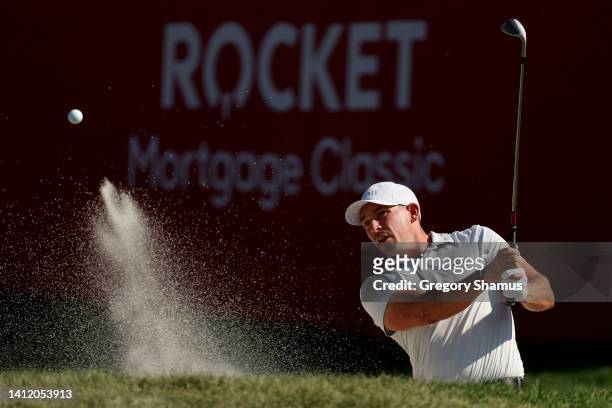 Scott Stallings of the United States plays his shot from the bunker on the 17th hole during the final round of the Rocket Mortgage Classic at Detroit...