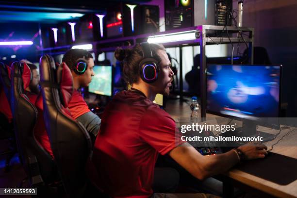 playing a game - internet cafe stock pictures, royalty-free photos & images