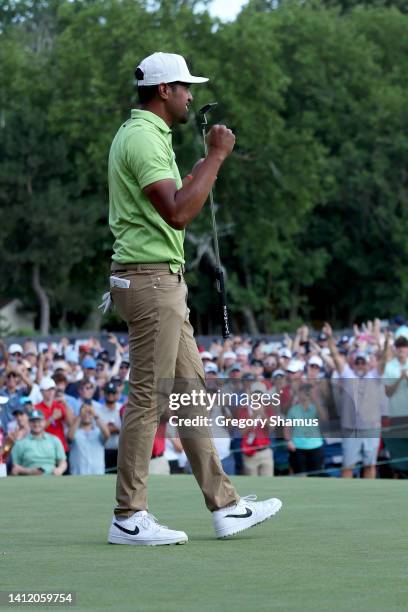 Tony Finau of the United States celebrates on the 18th green after winning the Rocket Mortgage Classic at Detroit Golf Club on July 31, 2022 in...