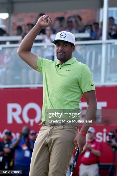 Tony Finau of the United States celebrates on the 18th green after winning the Rocket Mortgage Classic at Detroit Golf Club on July 31, 2022 in...