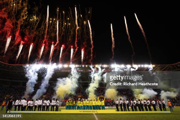 Gold Medalists, Team Australia Silver Medalists, Team Fiji and Bronze Medalists, New Zealand stand on the podium as fireworks are set off during the...