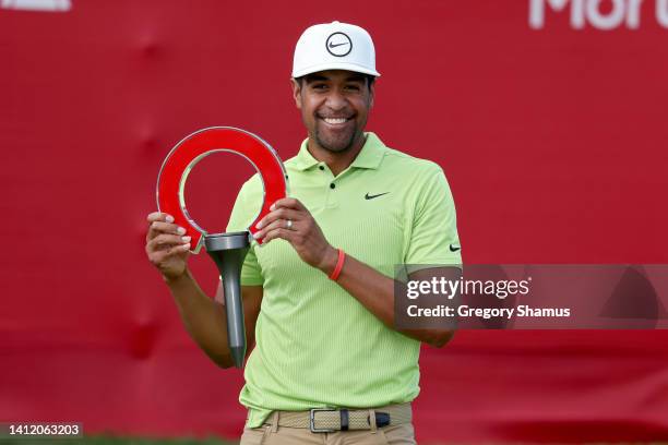 Tony Finau of the United States celebrates with the trophy after winning the Rocket Mortgage Classic at Detroit Golf Club on July 31, 2022 in...