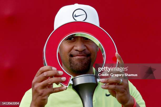 Tony Finau of the United States celebrates with the trophy after winning the Rocket Mortgage Classic at Detroit Golf Club on July 31, 2022 in...