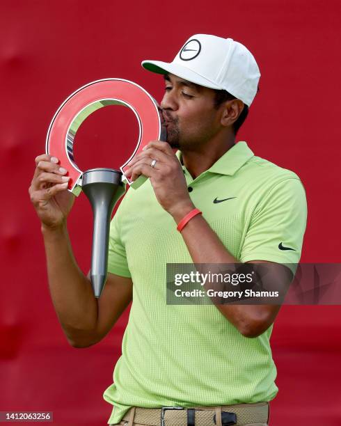 Tony Finau of the United States kisses the trophy after winning the Rocket Mortgage Classic at Detroit Golf Club on July 31, 2022 in Detroit,...