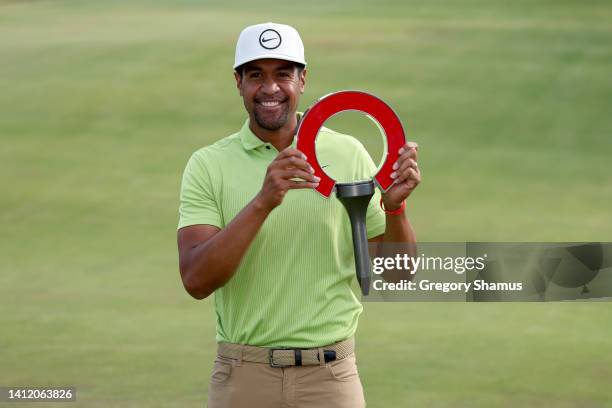 Tony Finau of the United States poses with the trophy after winning the Rocket Mortgage Classic at Detroit Golf Club on July 31, 2022 in Detroit,...