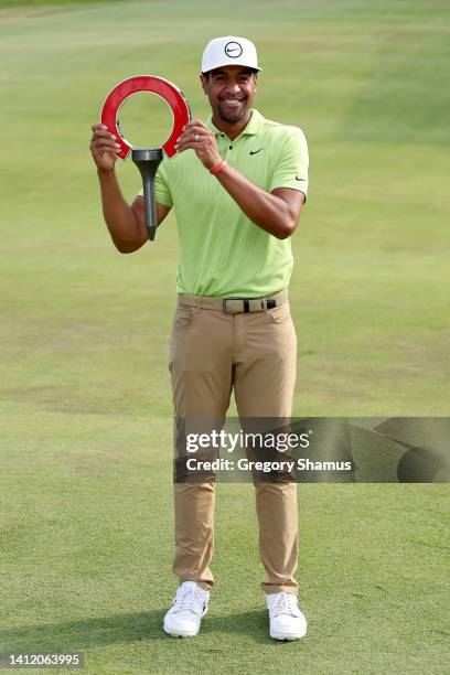 Tony Finau of the United States poses with the trophy after winning the Rocket Mortgage Classic at Detroit Golf Club on July 31, 2022 in Detroit,...