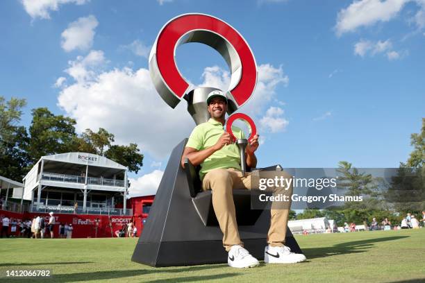Tony Finau of the United States poses with the trophy after winning the Rocket Mortgage Classic at Detroit Golf Club on July 31, 2022 in Detroit,...